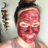 Hibiscus & Rose Exfoliating Mask on woman's face